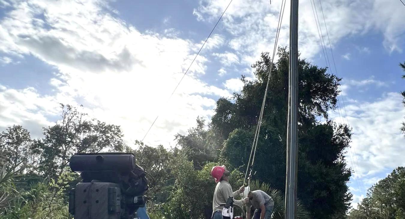 Lineworkers in boat restoring power